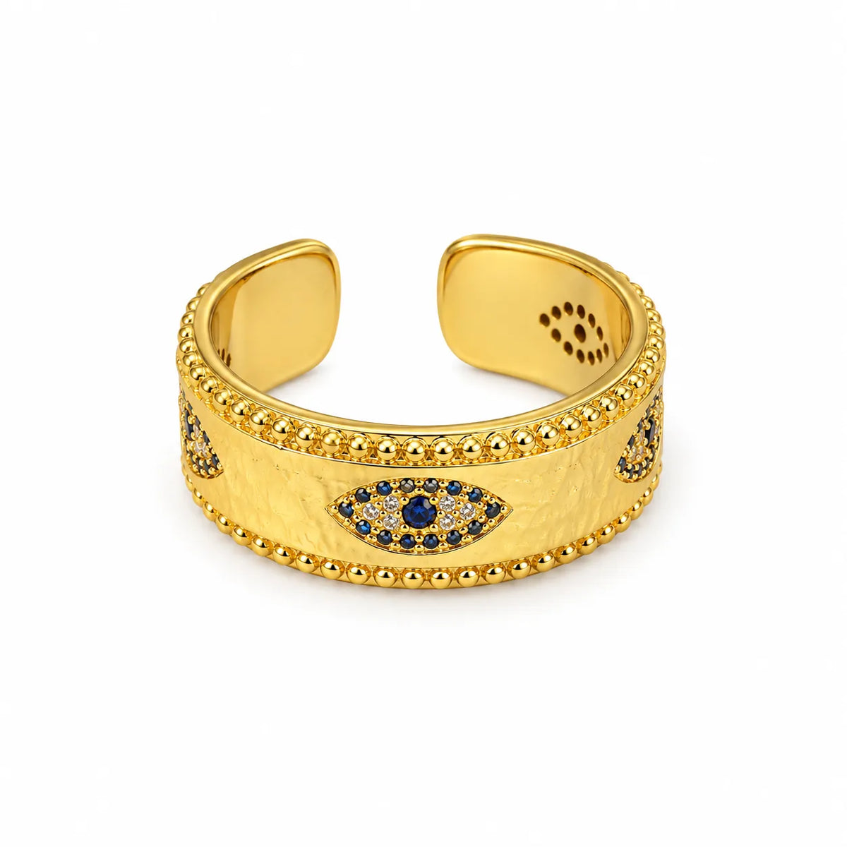 Wide hammered gold-plated band ring set with three sapphire-blue evil eye stones