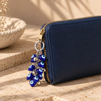 Eye Candy evil eye keychain clipped to a bag, Kharze Zarka